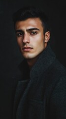 Obraz premium Portrait of Young Arab Man with Serious Expression Wearing Dark Overcoat
