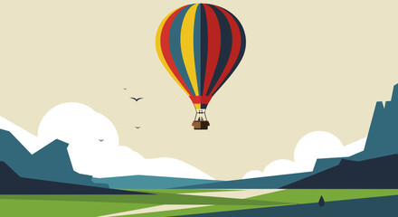 Colorful hot air balloon flying over mountains and fields in daylight  