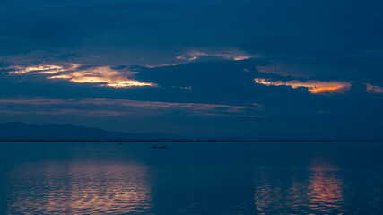 Dramatic Sky over Calm Water at Night