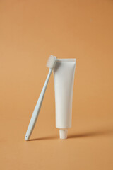 Toothbrush diagonally aligned on split-color surface of green and yellow. Minimalist presentation suitable for healthcare advertising or daily hygiene branding.