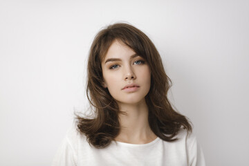Fototapeta premium Young Woman With Natural Beauty Posing In Casual White Top 