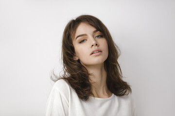 Obraz premium Natural Beauty Of Young Woman In Casual White Outfit On Neutral Background 