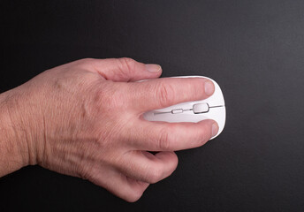 Hand holding a computer mouse, symbolizing digital interaction, navigation, work, and modern...