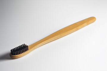 eco-friendly bamboo toothbrush placed on clean white