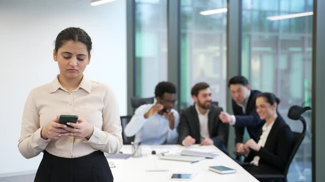 Harassment in office at workplace. Coworkers employees group man and woman Whispering Behind Back colleagues gossiping young specialist worker workmate problem at work indoor