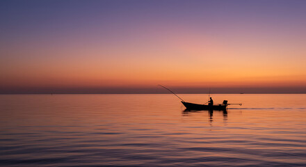 Fototapeta premium Serene Sunset Silhouette Fisherman in Small Boat at Sea Peaceful Twilight Scene