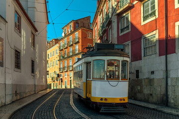 Vintage tram on a narrow street in Lisbon, Portugal.
