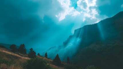 through dramatic clouds above mountain peaks