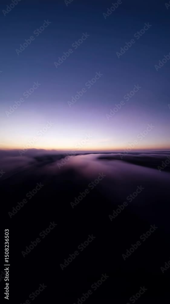 Poster a blurry image of a cloudy sky with a purple hue. the sky is filled with clouds and the sun is setti