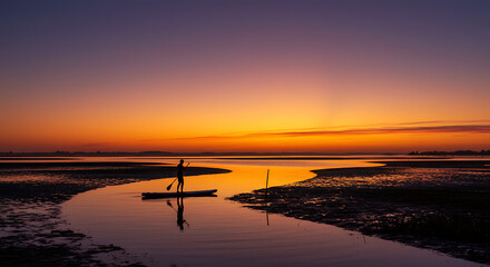 Stand Up Paddleboarding Silhouette at Sunset Calm Water Coastal Scene