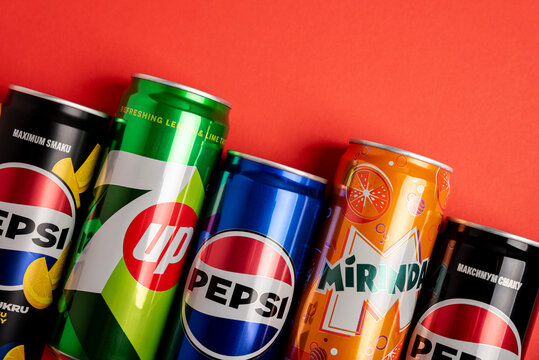 Lviv, Ukraine - May 25, 2025: border from Pepsi Zero Sugar Soda, Classic Soda, Zero Sugar Citrus Soda, 7up and Mirinda Cans on red background. Top view