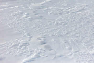 The snow is white and the ground is covered in it