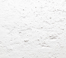 A white wall with a rough texture