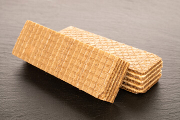 Two sweet waffles, macro, on slate stone.