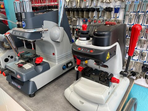 Portals Nous, Spain - May 27, 2025: Key cutting machines in a locksmith workshop, showcasing advanced technology and tools for precision key duplication and locksmith services