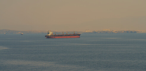 A merchant ship at anchor near the port