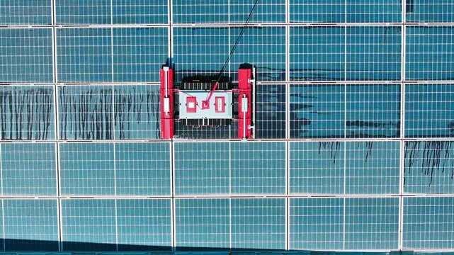Robot cleans solar panels - 4k drone footage of robot cleaning solar panels