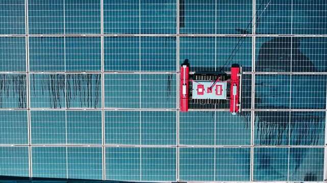Robot cleans solar panels - 4k drone footage of robot cleaning solar panels