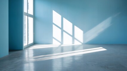 Obraz premium Empty blue room interior with bright sunlight creating shadows on the floor and wall