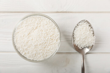 Set of fresh whole and half coconuts and slices on wooden background. Coconut flakes. Vegan. Tropical nut, fruit. Place for text. Copy space.