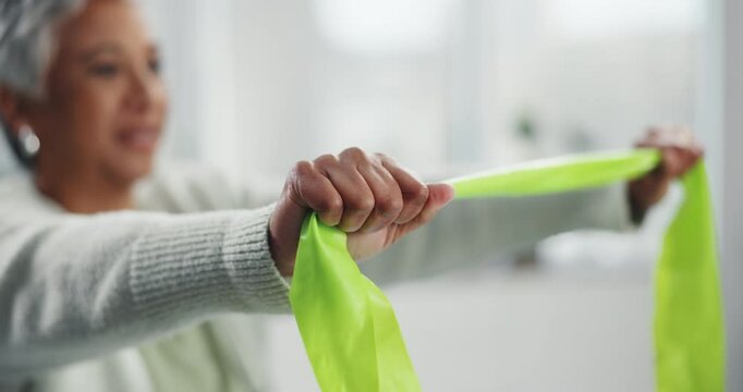 Hands, rehabilitation and resistance band with mature woman in clinic for exercise or training. Health, fitness and wellness with person stretching equipment for physical therapy or recovery