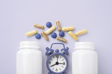 Supplement tablet, beauty vitamin capsule with white bottle and alarm clock on pastel purple background, top view