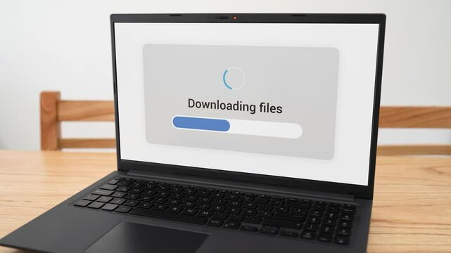 Computer screen downloading files with blue progress bar.
