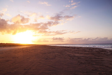 Bright sunset on the coast by the ocean. Beautiful landscape