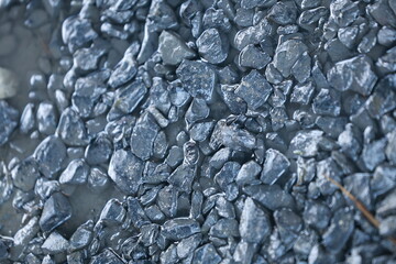 A close up of a rock wall with a variety of different sized rocks