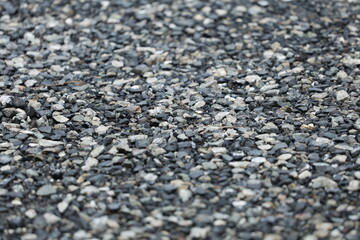 A close up of a rock wall with a variety of different sized rocks
