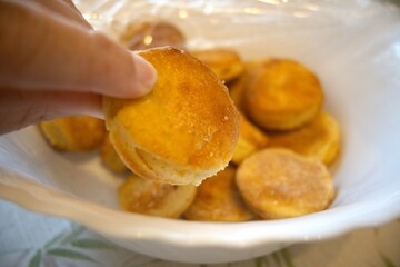 Potato patties in a bowl close up with hand
