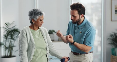 Physiotherapy, dumbbells and senior woman exercise for fitness, help or body health in clinic. Physical therapist, patient and strength training for muscle, rehabilitation or support for recovery