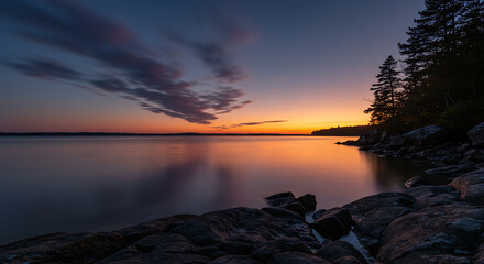 Serene Sunset Over Lake Colorful Sky Rocky Shore and Tranquil Waters