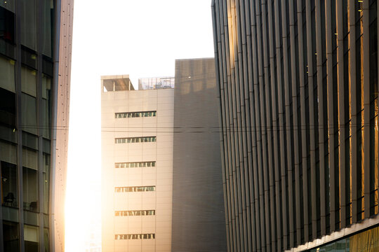 Modern glass office buildings with reflections, geometric lines, sunlight on facades, blue tones, Polanco, Ciudad de M&eacute;xico, urban architecture design