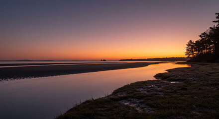 Serene Sunset Landscape Coastal Creek at Dusk with Silhouetted Trees and Calm Waters