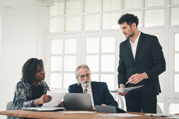 Young Hispanic businessman startup working meeting or brainstorm marketing business plan with senior partner or customer at workplace, professional diverse teamwork employees conference together