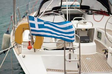 Luxury motor-boat in Crete Island, Greece. a Greek flag stands out prominently. A marina showcasing sailboats and motor yachts . a boat with a Greek flag. High quality photo