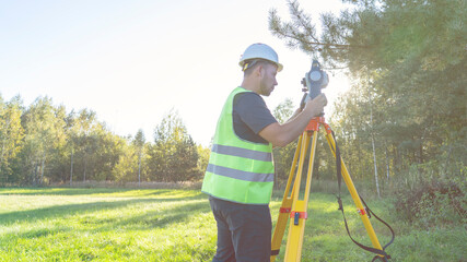 the surveyor behind the total station performs measurements.