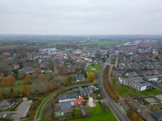 Obraz premium Geldermalsen, Netherlands - 03.15.2023 : Aerial view of a Dutch town in cloudy spring weather. The infrastructure of the Netherlands at high standards, a combination of old and new buildings 