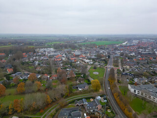 Geldermalsen, Netherlands - 03.15.2023 : Aerial view of a Dutch town in cloudy spring weather. The infrastructure of the Netherlands at high standards, a combination of old and new buildings 