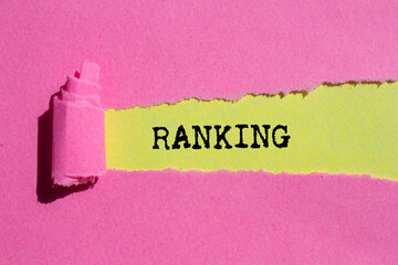 Ranking message written on ripped torn pink paper on yellow background. Conceptual ranking symbol....