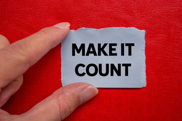 Make it count message written on ripped torn grey paper piece on red background. Conceptual make it...