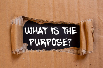 What is the purpose message written on ripped torn cardboard paper on black background. Conceptual...