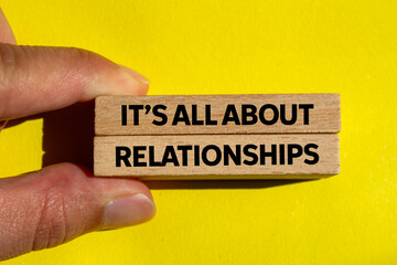 It’s all about relationships message written on wooden blocks on yellow background. Conceptual it’s all about relationships symbol. Copy space.