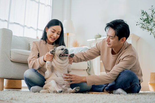 Asian family stay at home together with dog on holiday. Love couple lifestyle.
