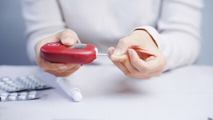 Blood glucose meter diabetes test hand finger red close up healthcare medical device white background