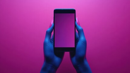 Hands holding smartphone against pink background