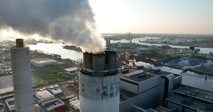 Close up view on smoking, steaming, chimney, industrial facility, factory, carbon emission, heavy industry. Industrial waste. Aerial close up view.