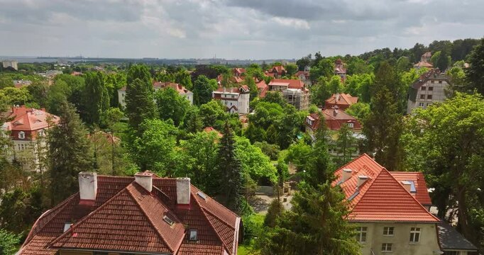 Aerial view backwards over traditonal houses in Poland, sunny, summer day