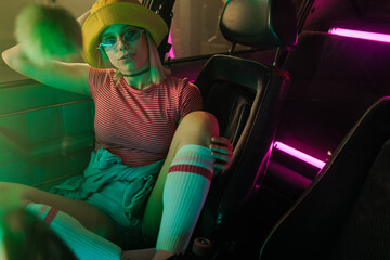 Cheerful stylish woman in car.
